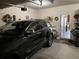 Well-lit garage with storage area, showcasing a dark SUV and access door to inside the home at 1291 Long Acre Dr, Loganville, GA 30052