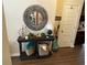 A staged hallway area with modern mirror and lamps on a side table with an open door at 1291 Long Acre Dr, Loganville, GA 30052