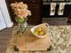 Granite kitchen countertop with decorative accents including fresh lemons, flowers, and a wooden cutting board at 1291 Long Acre Dr, Loganville, GA 30052