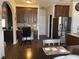 Spacious kitchen with stainless steel refrigerator, dark cabinetry, and convenient workstation nook at 1291 Long Acre Dr, Loganville, GA 30052