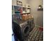 Functional laundry room with modern washer and dryer and open shelving for storage at 1291 Long Acre Dr, Loganville, GA 30052