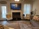 Warm living room features fireplace, TV, cozy seating, stylish décor for relaxed Gathering entertainment at 1291 Long Acre Dr, Loganville, GA 30052