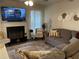 Cozy living room features a fireplace with a TV, comfortable seating, and stylish decor for relaxed living at 1291 Long Acre Dr, Loganville, GA 30052