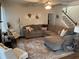 Spacious living room features a large sectional sofa, decorative rug, and staircase leading to the upper level at 1291 Long Acre Dr, Loganville, GA 30052
