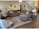 Bright living room with a large sectional sofa, stylish rug, and staircase, perfect for Gathering gatherings at 1291 Long Acre Dr, Loganville, GA 30052