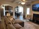 Inviting living room with cozy fireplace, plush sectional sofa, and open layout to the kitchen and dining area at 1291 Long Acre Dr, Loganville, GA 30052