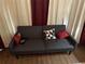 Comfortable gray futon with decorative pillows adds a cozy touch to the bedroom space at 1291 Long Acre Dr, Loganville, GA 30052