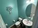 Charming powder room with a unique wall decor and classic fixtures, showcasing a clean design at 1291 Long Acre Dr, Loganville, GA 30052