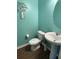 Stylish powder room featuring a pedestal sink and modern fixtures, illuminated by ample lighting at 1291 Long Acre Dr, Loganville, GA 30052