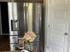 Stainless steel refrigerator with water dispenser and a bouquet of flowers on top at 1291 Long Acre Dr, Loganville, GA 30052