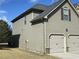 Side view of home showing neutral color scheme and large two-car garage at 1291 Long Acre Dr, Loganville, GA 30052