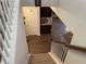 View of staircase leading down to the living area with wood flooring and a built-in bar area at 1291 Long Acre Dr, Loganville, GA 30052