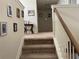 Carpeted stairway with painted walls and wooden railing, leading to the home's upper level at 1291 Long Acre Dr, Loganville, GA 30052