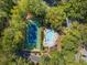 Aerial view of the community pool and tennis court surrounded by lush trees at 2707 Cumberland Se Ct, Smyrna, GA 30080