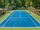 Overhead view of a well maintained outdoor tennis court surrounded by trees at 2707 Cumberland Se Ct, Smyrna, GA 30080