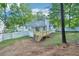 Back exterior view of home with deck, trees and white fence at 4787 Burford Nw Ct, Acworth, GA 30102