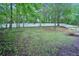 Spacious backyard with trees and a white fence at 4787 Burford Nw Ct, Acworth, GA 30102