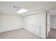 Basement featuring carpet, white walls, closets, and door to another room at 4787 Burford Nw Ct, Acworth, GA 30102