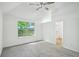 Bright bedroom with a vaulted ceiling, ceiling fan, large window, and neutral carpet at 4787 Burford Nw Ct, Acworth, GA 30102
