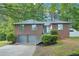 Charming brick home with a two-car garage, landscaped front yard, and inviting entrance at 4787 Burford Nw Ct, Acworth, GA 30102