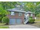 Charming brick home with a two-car garage, inviting staircase, and mature trees in a serene setting at 4787 Burford Nw Ct, Acworth, GA 30102