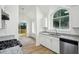 Modern kitchen with stainless steel appliances, granite countertops, and an arched window at 4787 Burford Nw Ct, Acworth, GA 30102
