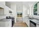 Well-lit kitchen with stainless steel appliances, granite countertops, and access to the outdoor deck at 4787 Burford Nw Ct, Acworth, GA 30102