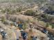 Aerial view displaying home's surrounding neighborhood, and wooded surroundings at 5659 Brookstone Nw Dr, Acworth, GA 30101