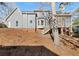 View of the home's backyard, showing the siding, screened porch, and landscaping at 5659 Brookstone Nw Dr, Acworth, GA 30101