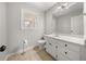 Bathroom featuring a tiled floor, white vanity and modern lighting fixture at 5659 Brookstone Nw Dr, Acworth, GA 30101