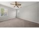 Bright bedroom with neutral carpet, ceiling fan, and windows offering natural light at 5659 Brookstone Nw Dr, Acworth, GA 30101
