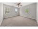 Well-lit bedroom with neutral carpet, ceiling fan, and large windows at 5659 Brookstone Nw Dr, Acworth, GA 30101