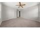 Spacious bedroom with neutral carpet, ceiling fan, and ample closet space at 5659 Brookstone Nw Dr, Acworth, GA 30101