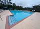 Large community pool with sun loungers and umbrellas for relaxation at 5659 Brookstone Nw Dr, Acworth, GA 30101