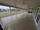 Large covered patio area with ceiling fans overlooking a well-manicured lawn and greenery at 5659 Brookstone Nw Dr, Acworth, GA 30101