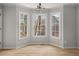 Bright dining area featuring three large windows and wood-look flooring at 5659 Brookstone Nw Dr, Acworth, GA 30101