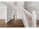 Bright foyer with hardwood floors, a staircase, and views into other living spaces at 5659 Brookstone Nw Dr, Acworth, GA 30101