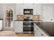 This kitchen features stainless steel appliances, granite countertops, and custom cabinetry at 5659 Brookstone Nw Dr, Acworth, GA 30101