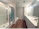 Bathroom featuring a shower and tub, double vanity, and modern finishes at 2059 Lanier Harbor Pt, Buford, GA 30518