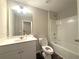 Bathroom featuring a vanity with a mirror, toilet, and bathtub shower combination at 2059 Lanier Harbor Pt, Buford, GA 30518