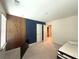 Cozy bedroom with accent wall, wooden slat wall, and comfortable sleeping space at 2059 Lanier Harbor Pt, Buford, GA 30518