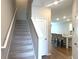 Entryway with stairs leading to the main living area and open view to the kitchen at 2059 Lanier Harbor Pt, Buford, GA 30518