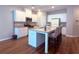 Bright kitchen with stainless appliances, granite counters, white cabinets, and seating at the island at 2059 Lanier Harbor Pt, Buford, GA 30518