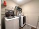 Convenient laundry room featuring a modern washer and dryer set, plus shelving for easy storage solutions at 2059 Lanier Harbor Pt, Buford, GA 30518