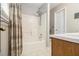 Bathroom with a shower over tub combination featuring a linen curtain and a wood vanity at 3979 White Owl Nw Ct, Duluth, GA 30097