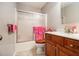 Bathroom featuring wood cabinets, a shower with glass doors and decorative mirror at 3979 White Owl Nw Ct, Duluth, GA 30097