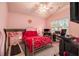 Pink bedroom featuring a bed, treadmill, desk, television, and natural light from the window at 3979 White Owl Nw Ct, Duluth, GA 30097