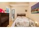 Cozy bedroom featuring a full-sized bed, dark wood dresser, and natural light from the window at 3979 White Owl Nw Ct, Duluth, GA 30097