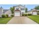 Charming two-story home featuring a brick-accented garage and manicured lawn at 3979 White Owl Nw Ct, Duluth, GA 30097