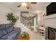 Comfortable living room with fireplace, plush sofa, and staircase view at 3979 White Owl Nw Ct, Duluth, GA 30097